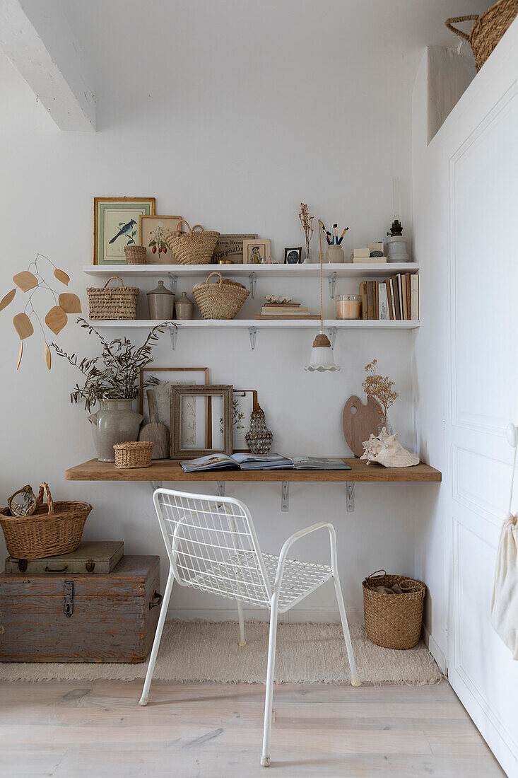 Wall shelf with decorative items and white metal chair