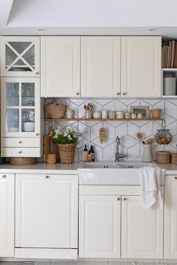 Country kitchen with white cabinets and geometric tile pattern