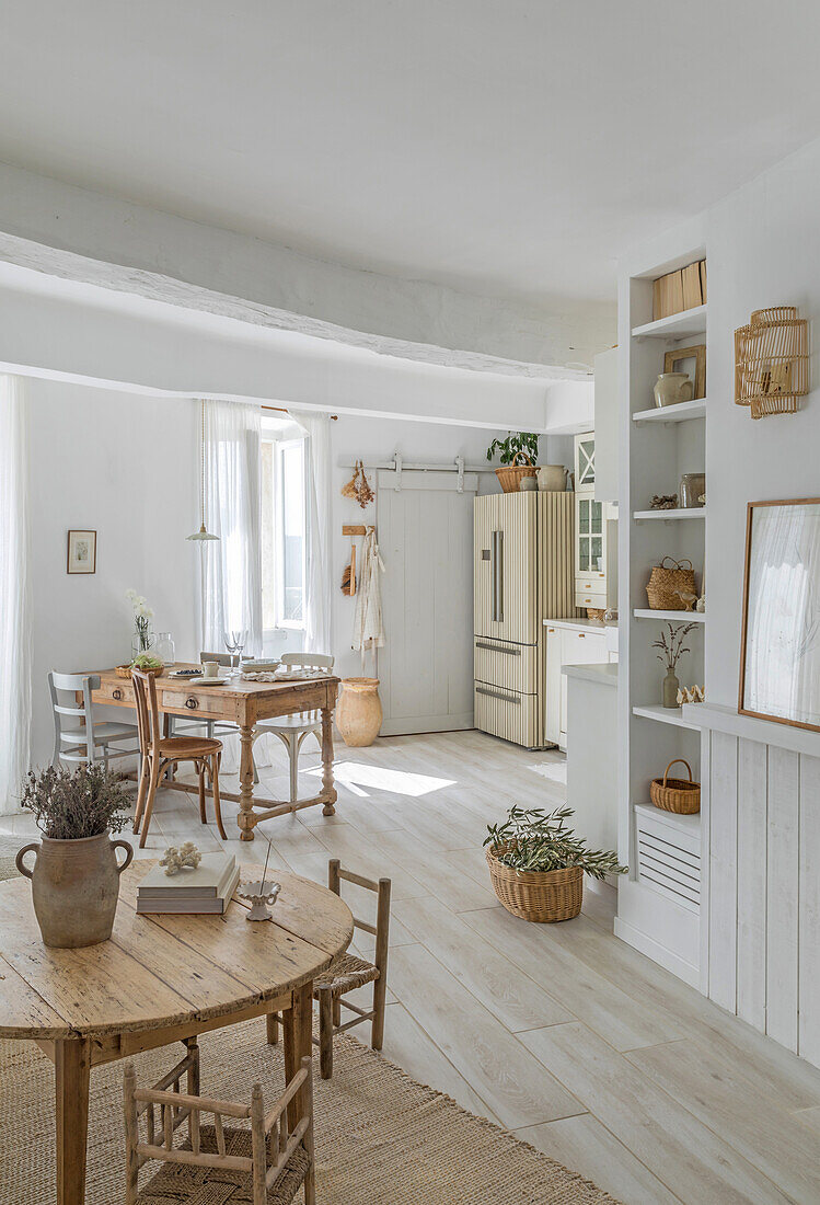 Bright country-style dining room with wooden furniture and sisal carpet