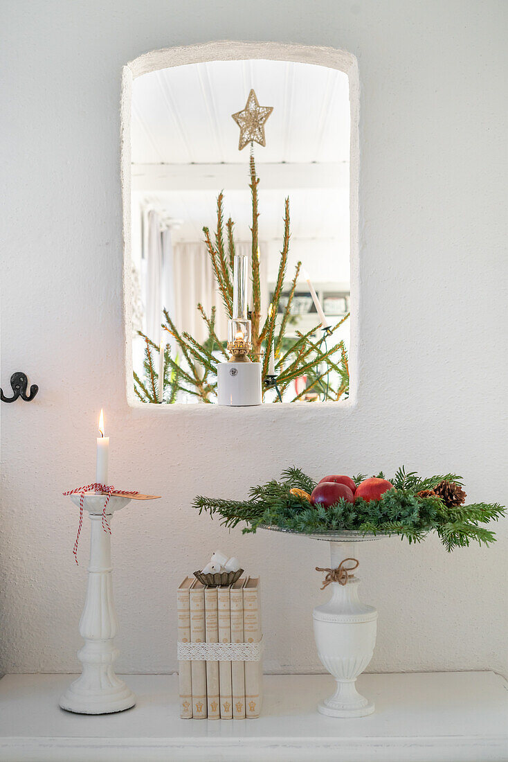 Christmas decorations with candles, books and fir branches