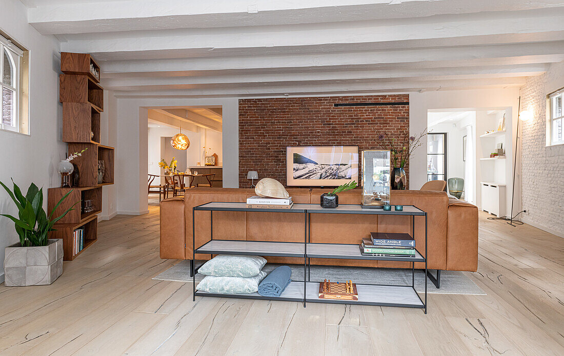 Spacious living room with brick wall and modern furniture