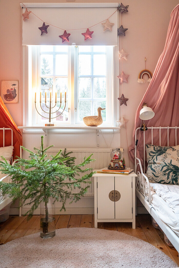 Children's room with Christmas decorations, Christmas tree and menorah in the window