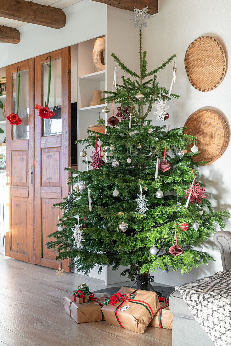 Decorated Christmas tree with presents in the living room