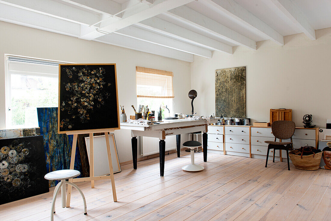 Bright artist's studio with easel and painting utensils