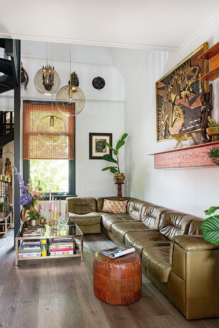 Living room with green leather sofa and decorative pendant lights