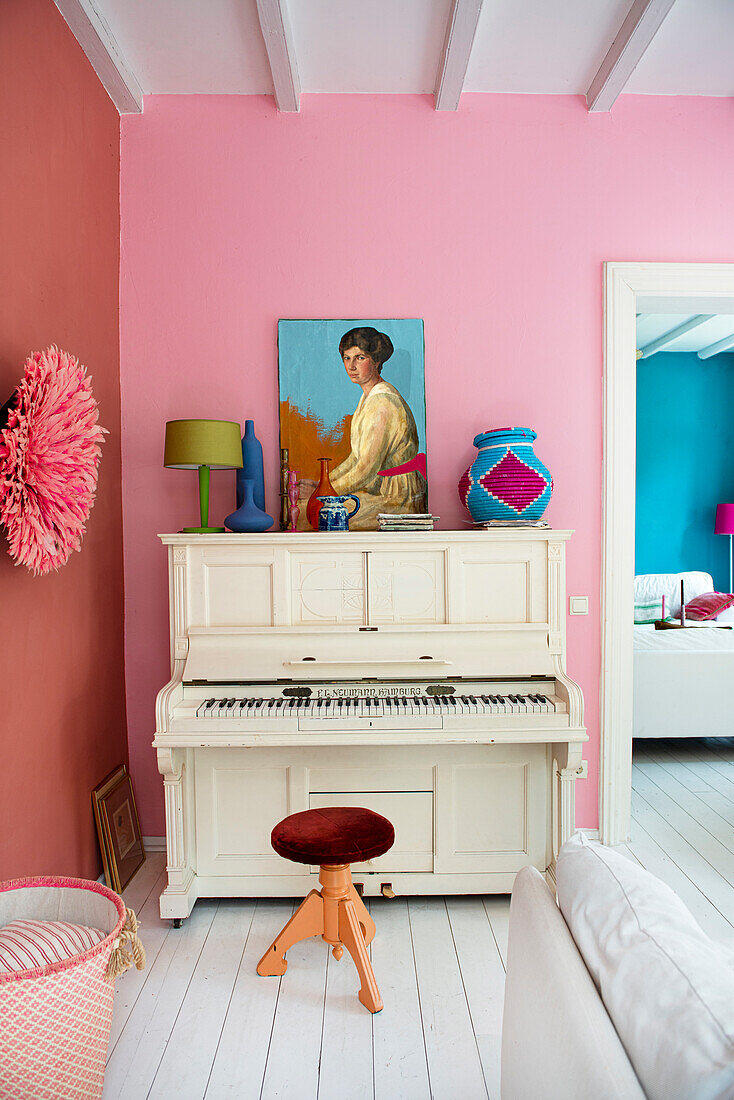 Colorful living area with white piano and contrasting decorative elements