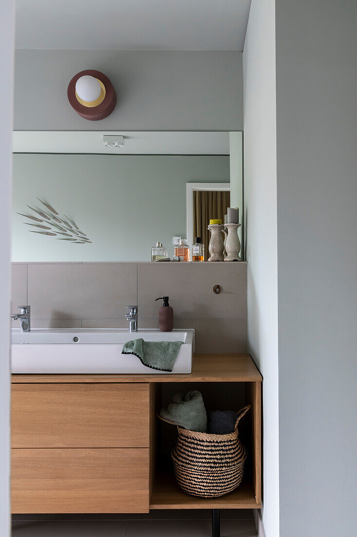 Minimalist bathroom with wall mirror and wooden vanity unit