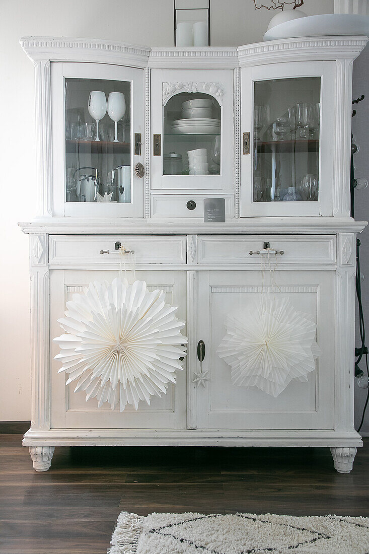 White vintage kitchen buffet with homemade paper stars