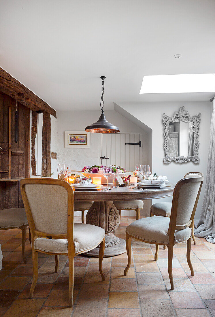 Traditional dining room with covered stone table and vintage chairs