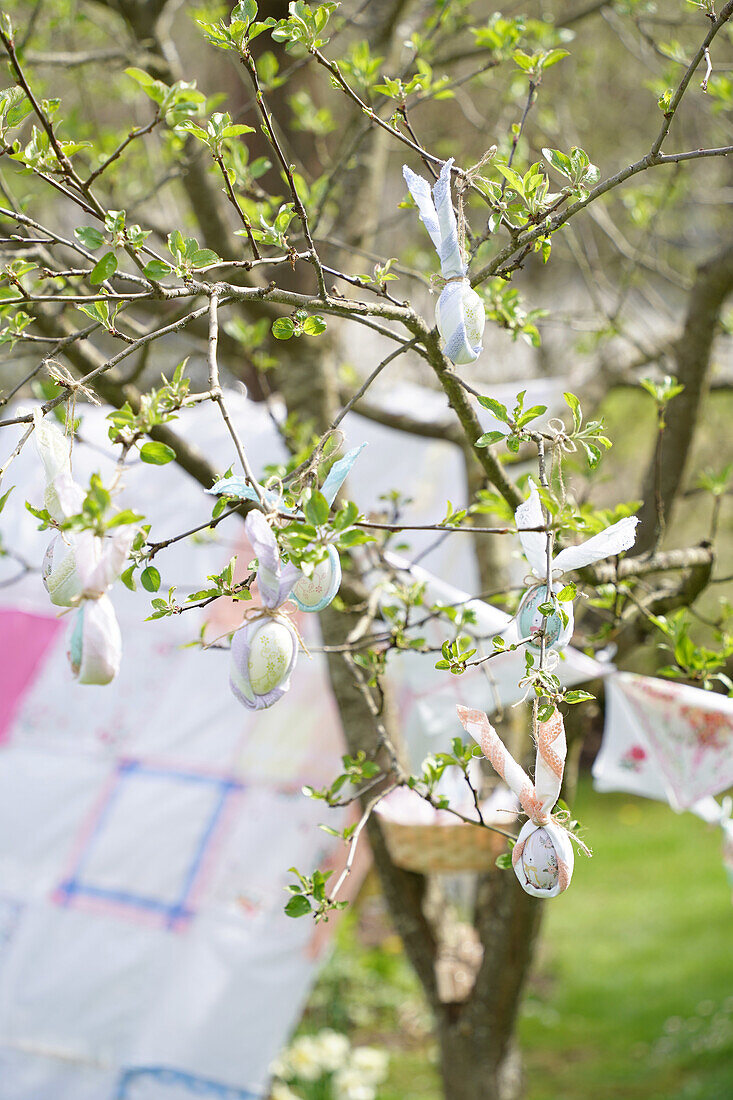 Apple tree with Easter decoration and pennant chain in the garden