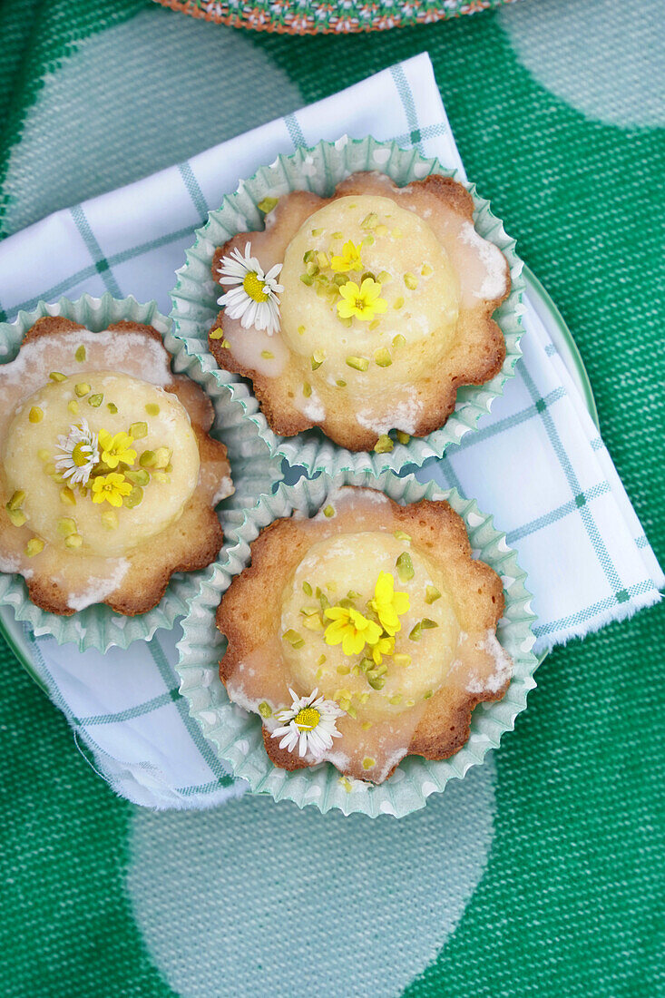 Flowery muffins with edible flowers on checkered cloth napkin