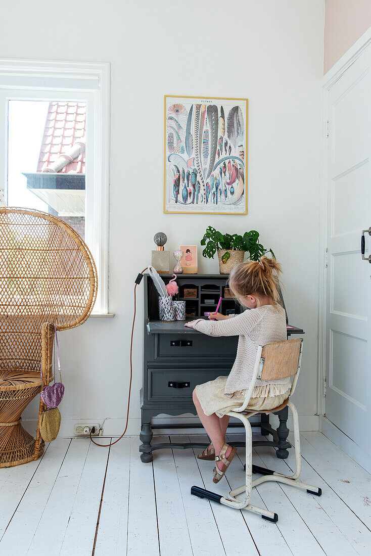 Vintage-style children's desk with Scandinavian decor and wall art