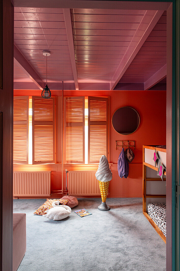 Children's room with orange wall and pink ceiling