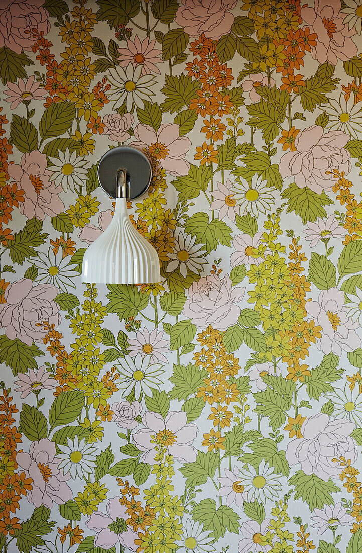 Floral wallpaper and wall mounted light fitting in Brighton home East Sussex, England, UK