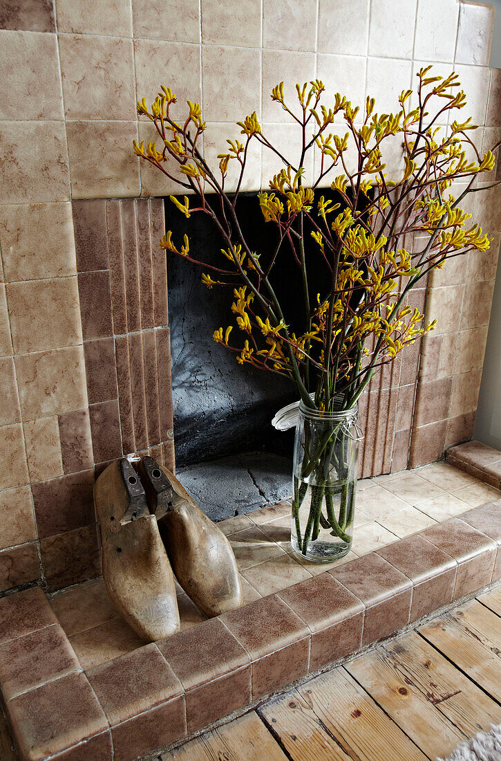 Antique shoe horns and cut flowers in vintage fireplace Brighton, East Sussex, England, UK