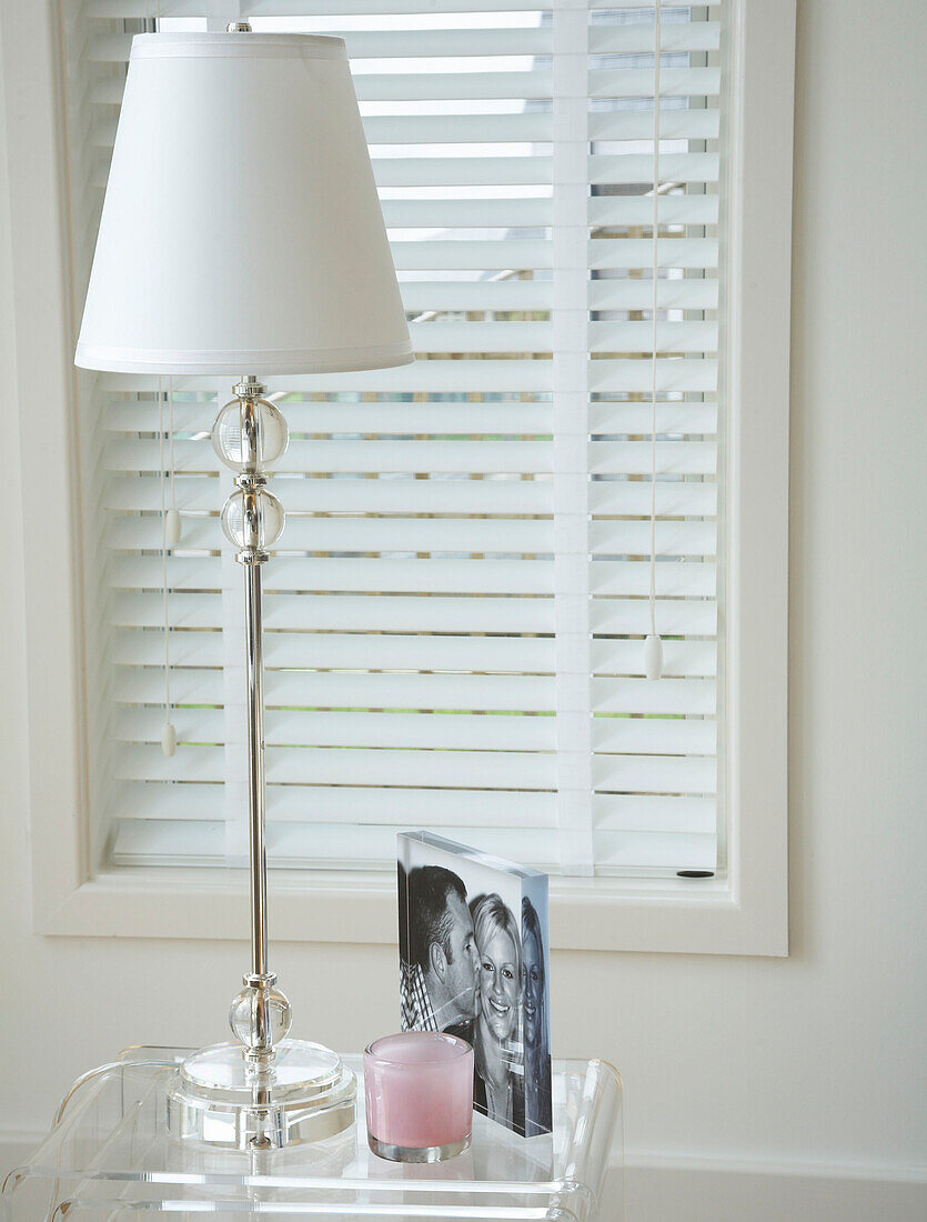 Venetian blind and a side table with lighting