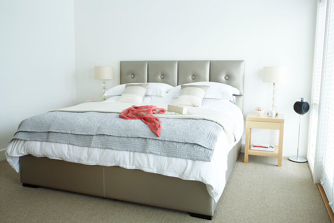 Neutral coloured bedroom with bedspread and button back headboard