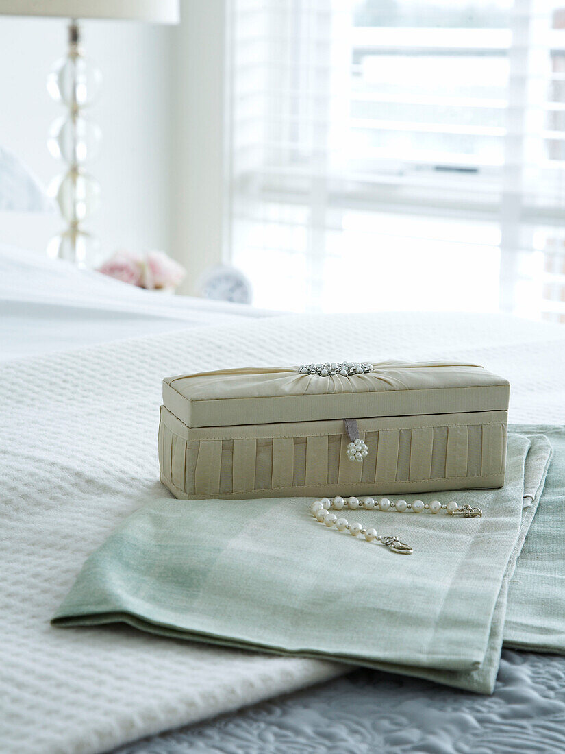 Jewellery box on a bed