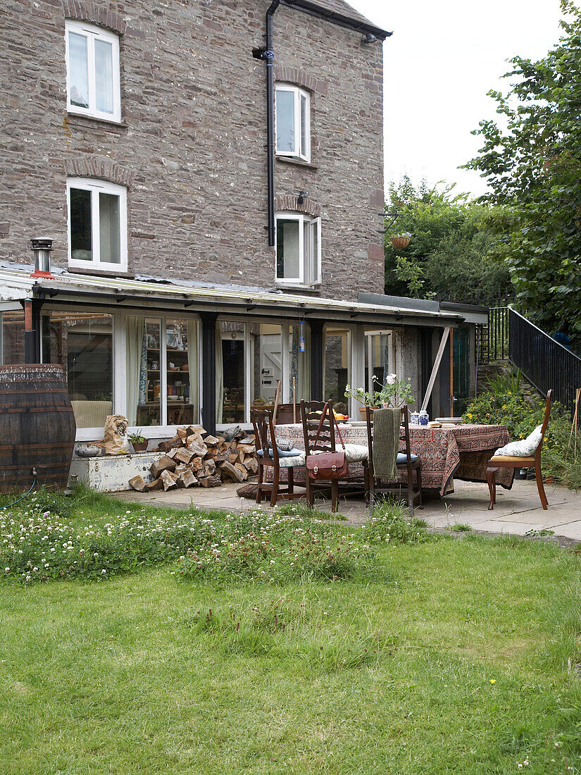 Exterior and back garden of a period home with table and chairs