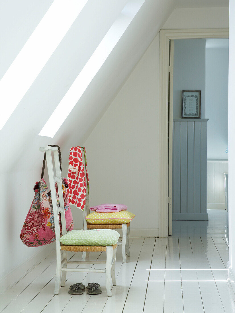 Chairs in an attic room with skylight windows