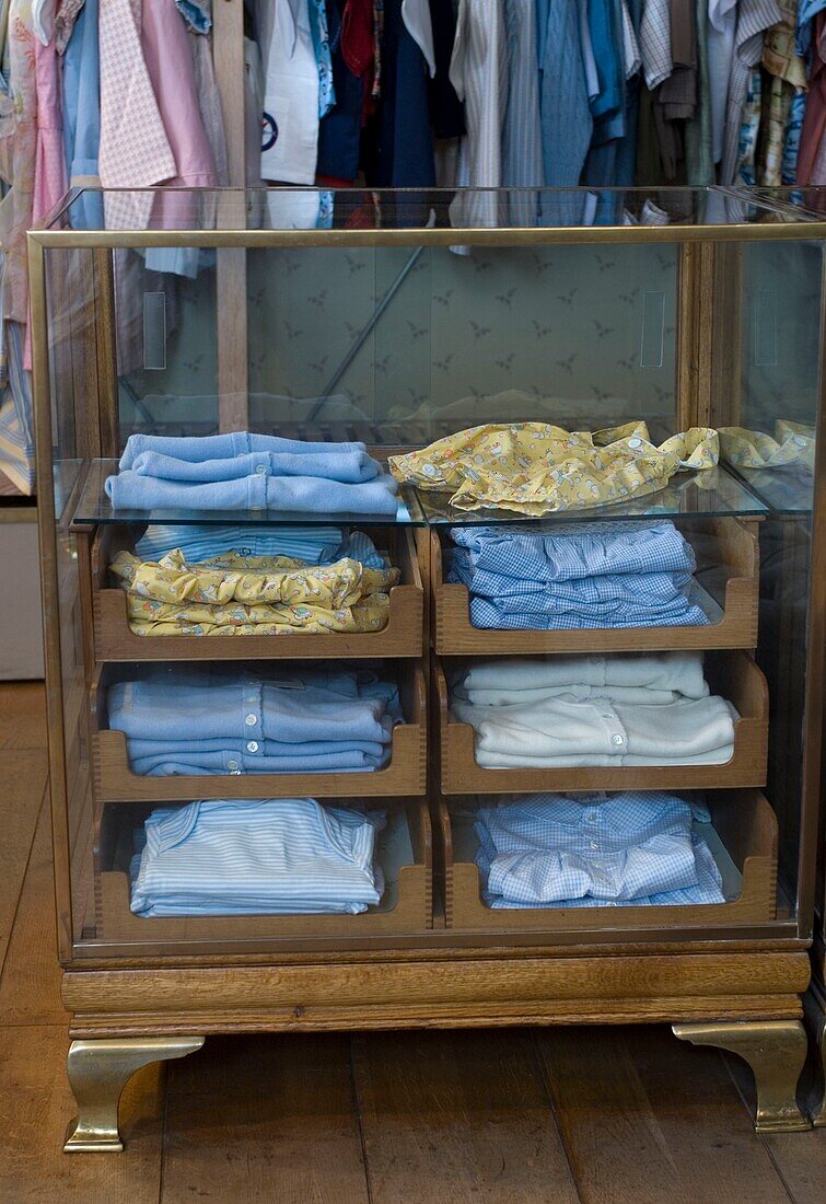 Clothes in display cabinet in store