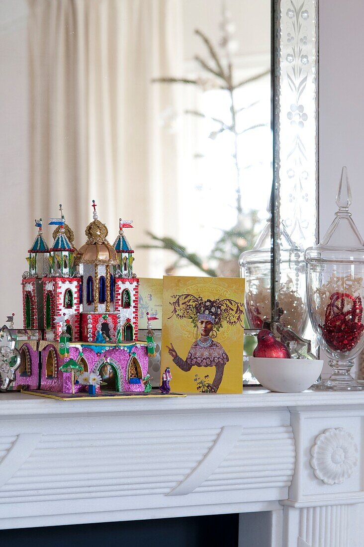 Christmas card and decorations on mantlepiece