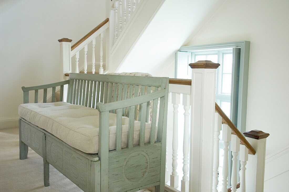 Wooden rustic sofa in staircase
