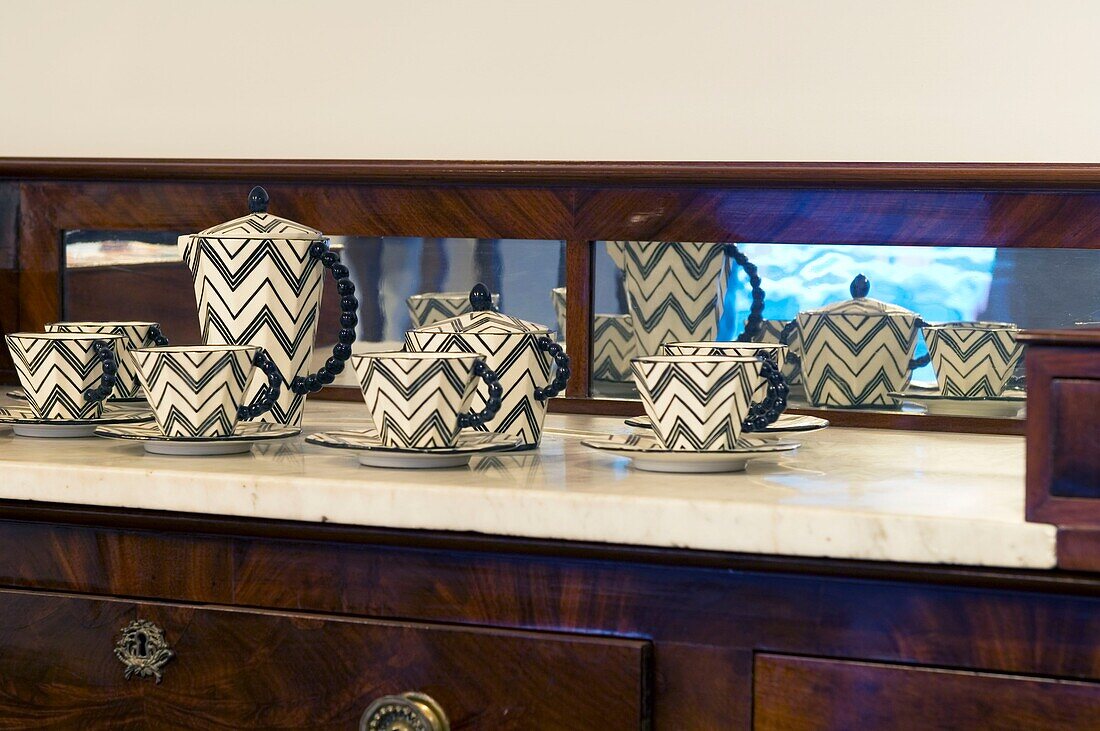 Porcelain set with zigzag pattern on the cupboard