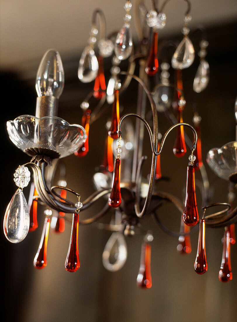 Detail of hanging chandelier light with coloured glass droplets