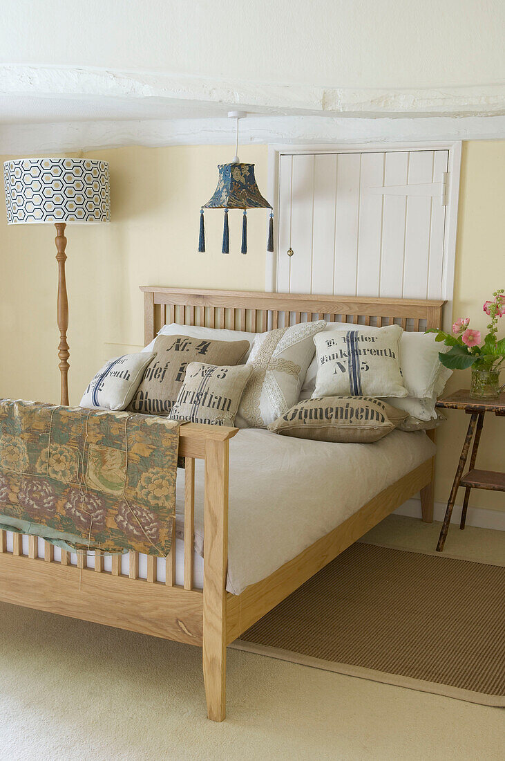 Double bed and standard lamp in Suffolk home, England, UK