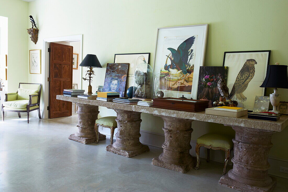 Art collection and books displayed on stone table in Massachusetts home, New England, USA