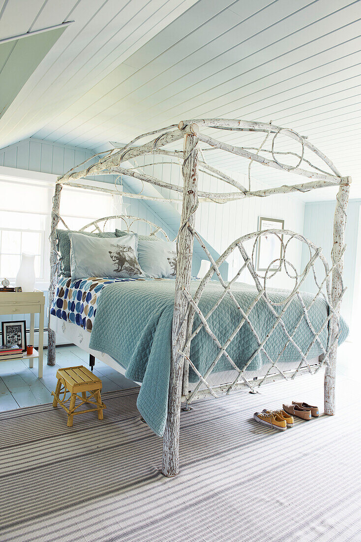 White four poster bed with light blue and spotted quilts in Berkshires home, Massachusetts, Connecticut, USA
