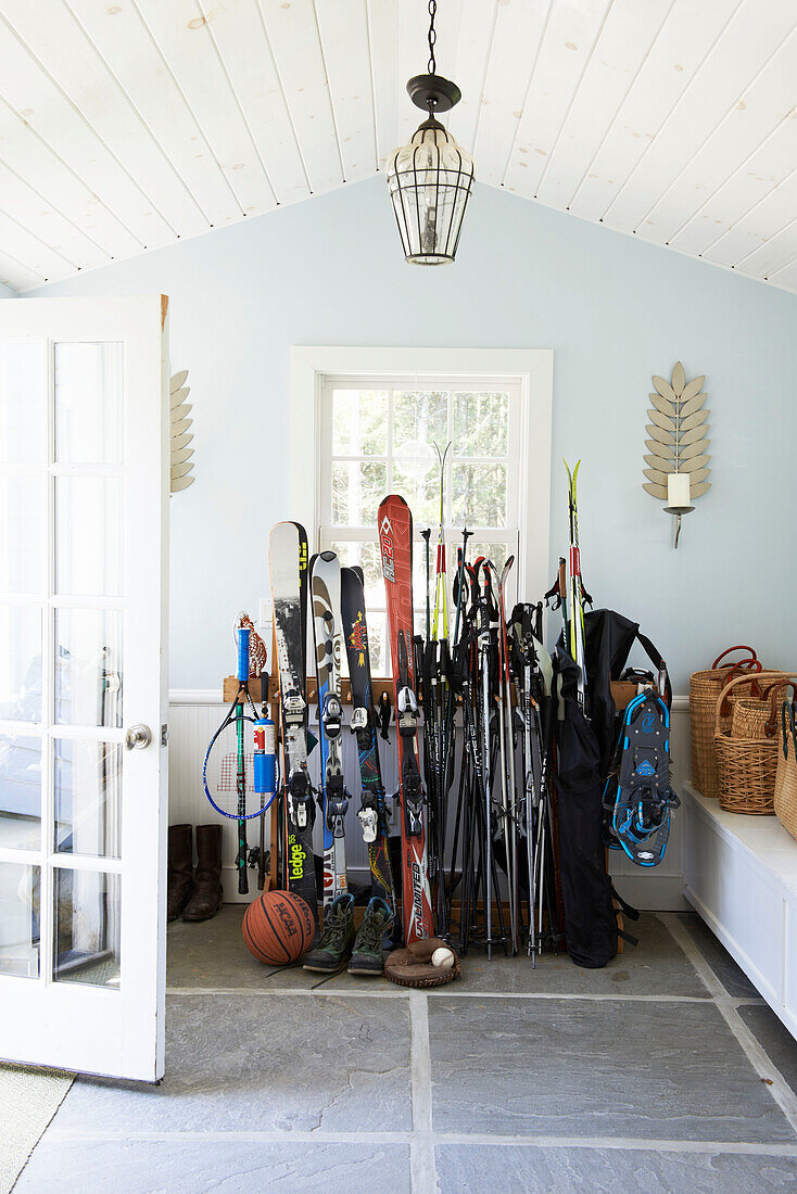 Sports equipment for skiing and basketball in entrance hallway of Austerlitz home, Columbia County, New York, United States