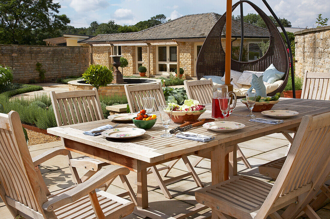 Al fresco dining in walled courtyard terrace of Lincolnshire country house, England, UK
