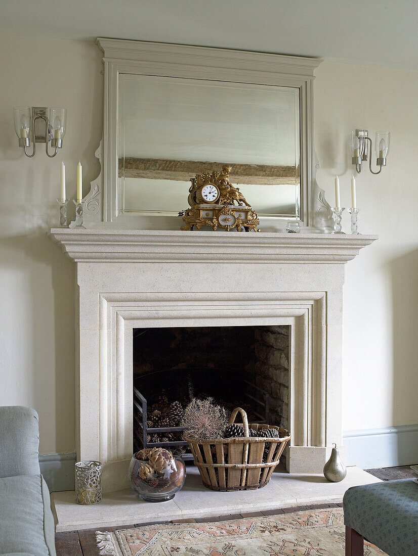 Antique gold clock and mirror on mantlepiece in Gloucestershire farmhouse, England, UK