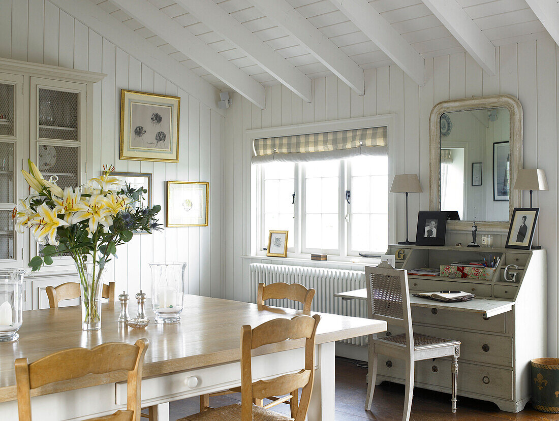 Kitchen table and writing desk in Hampshire farmhouse conversion England, UK