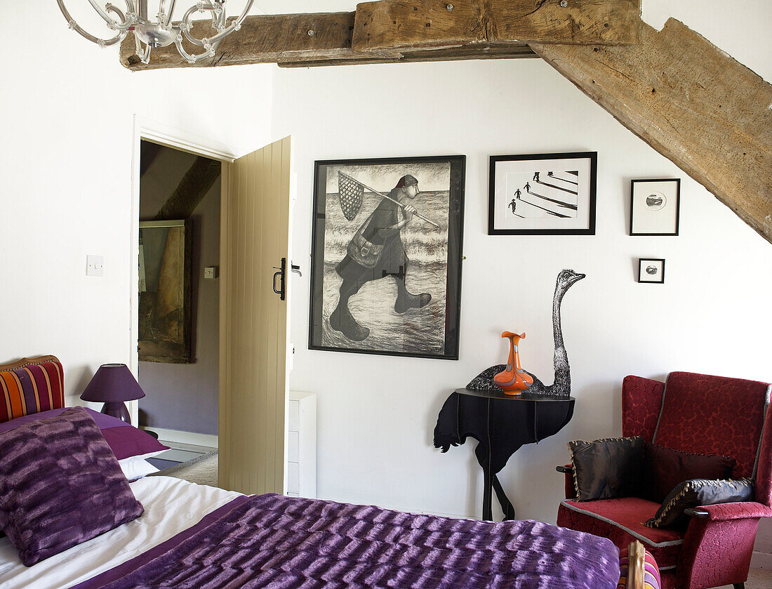 Ostrich wall detail and artwork in beamed bedroom of Welsh cottage, UK