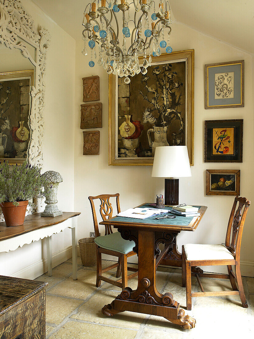 Desk and artwork with glass chandelier in Gloucestershire home, England, UK
