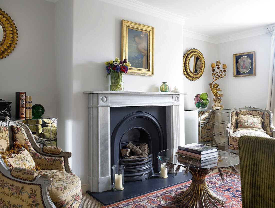 Floral armchairs and gilt framed mirrors and artwork in living room city of Bath Somerset, England, UK