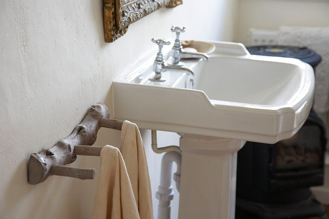Wooden towel hooks and pedestal base was stand in country house Suffolk, England, UK