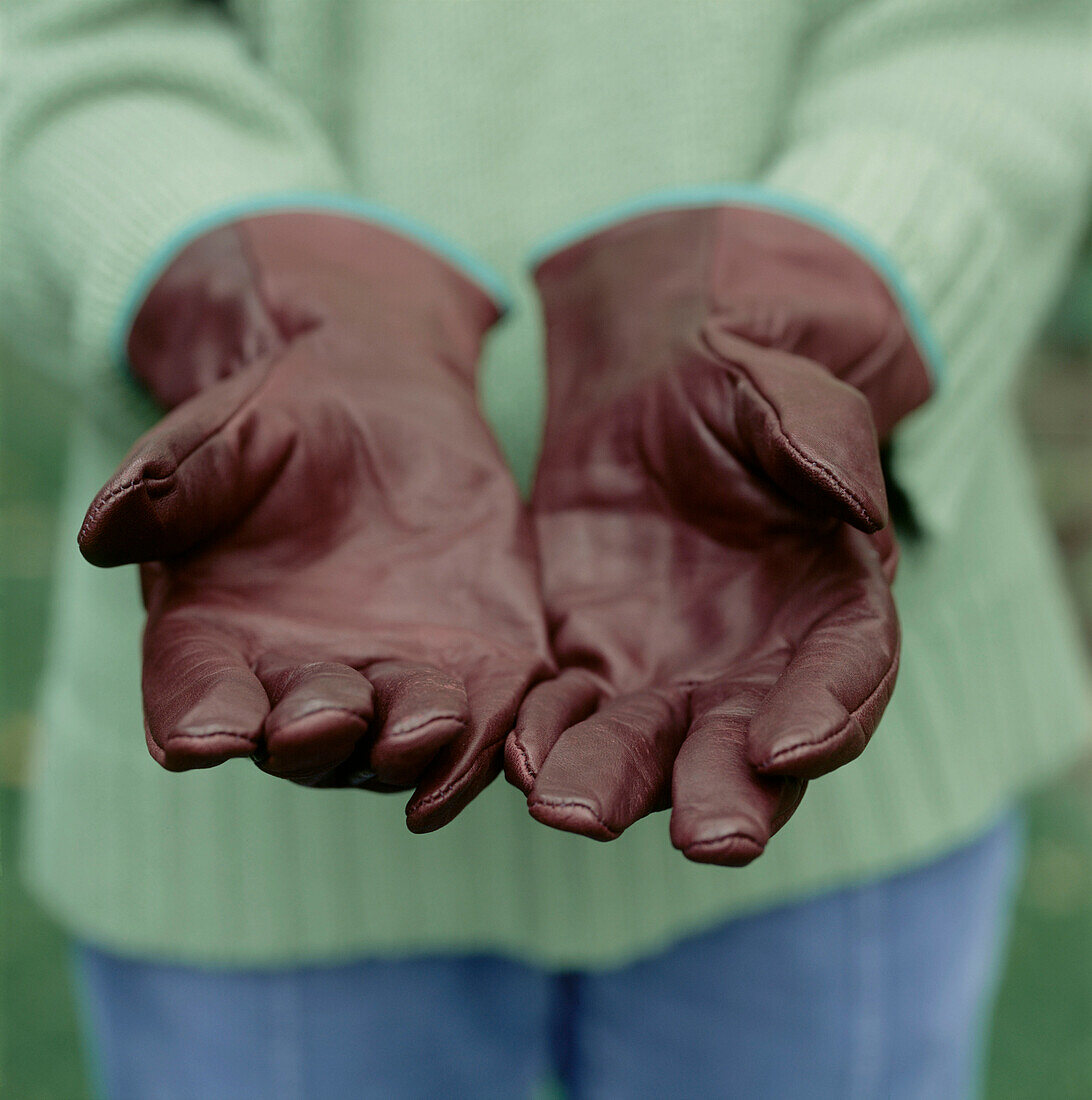 Woman wearing leather gardening gloves