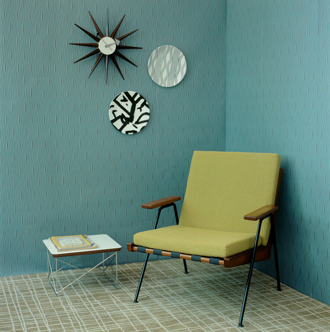 Green and turquoise contemporary Art Deco style living room detail with textured wallpaper armchair and home wares