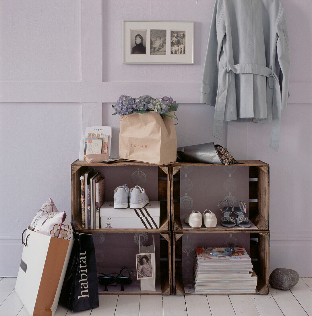 Make shift storage units from old wooden crates containing homeware and personal belongings