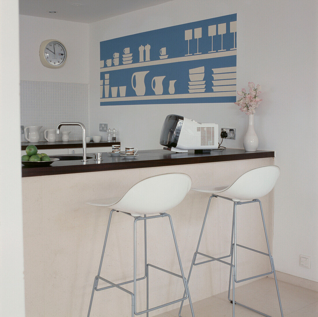 Contemporary coordinating kitchen with stone floor white stools and turquoise and white decor