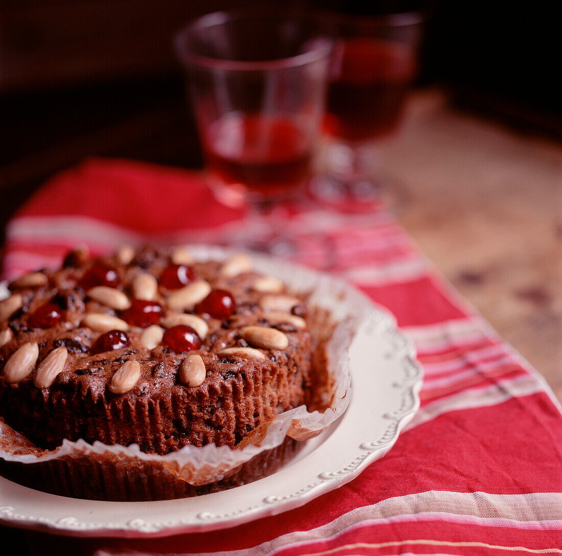 Homemade fruit and nut cake on a plate on a country style tabletop