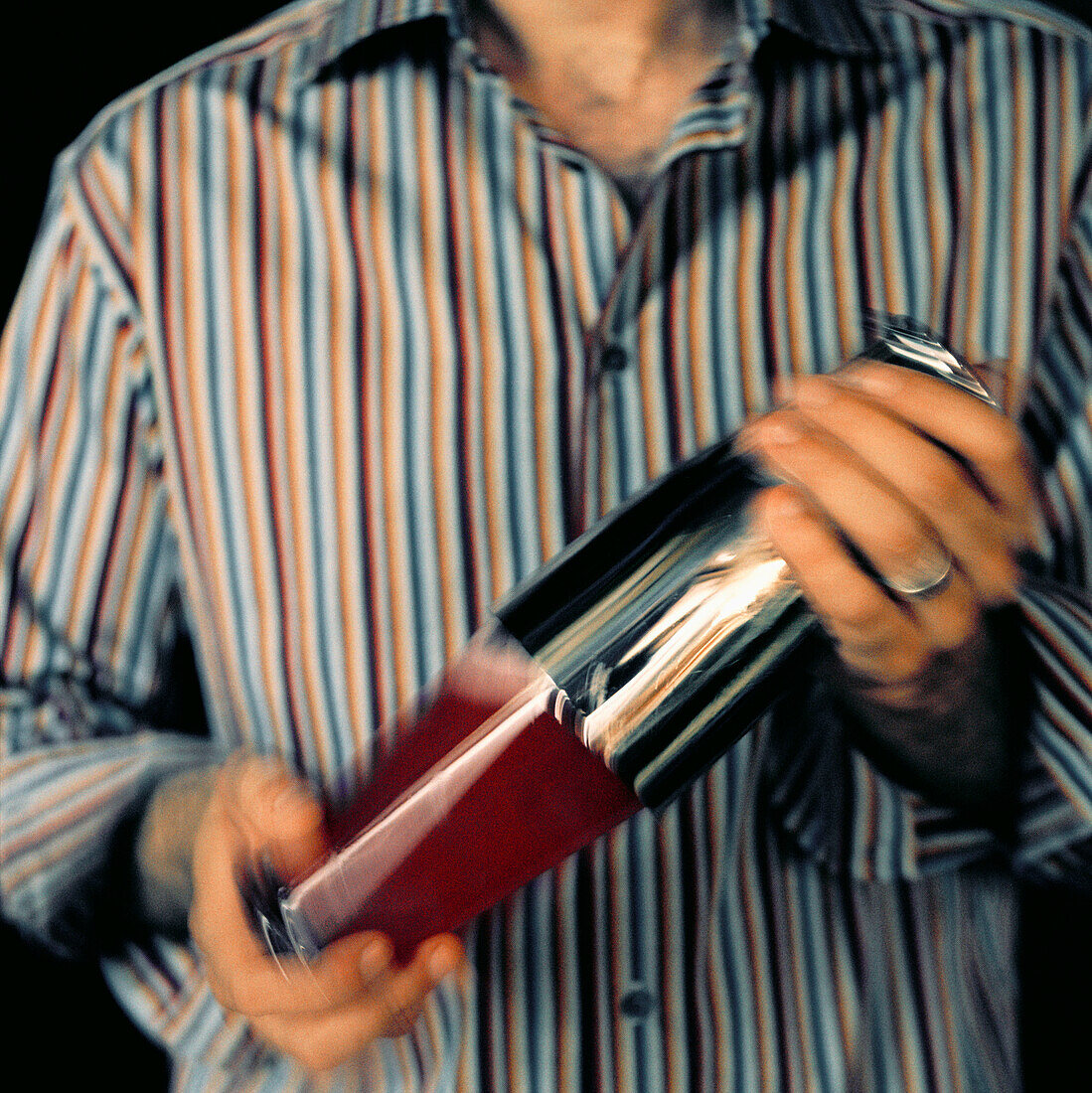 Man shaking a cocktail in a cocktail shaker