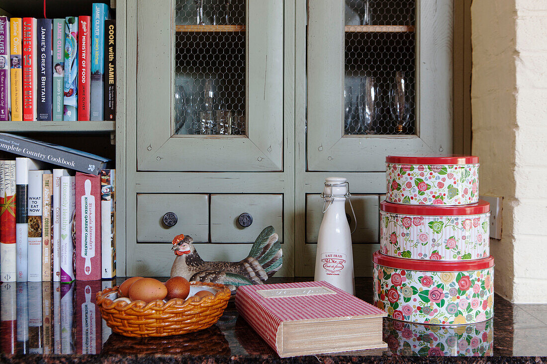 Cake tins and recipe books in kitchen detail of Surrey barn conversion England UK