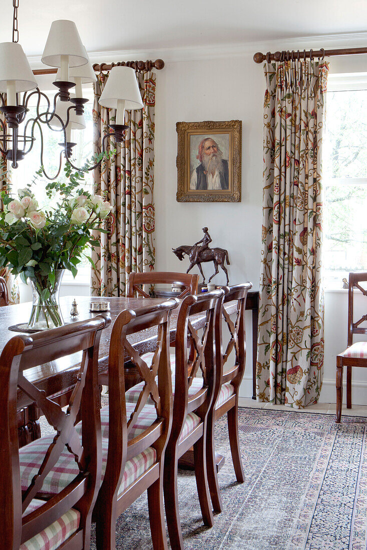 Polished wooden dining table and chairs in Wiltshire country house England UK