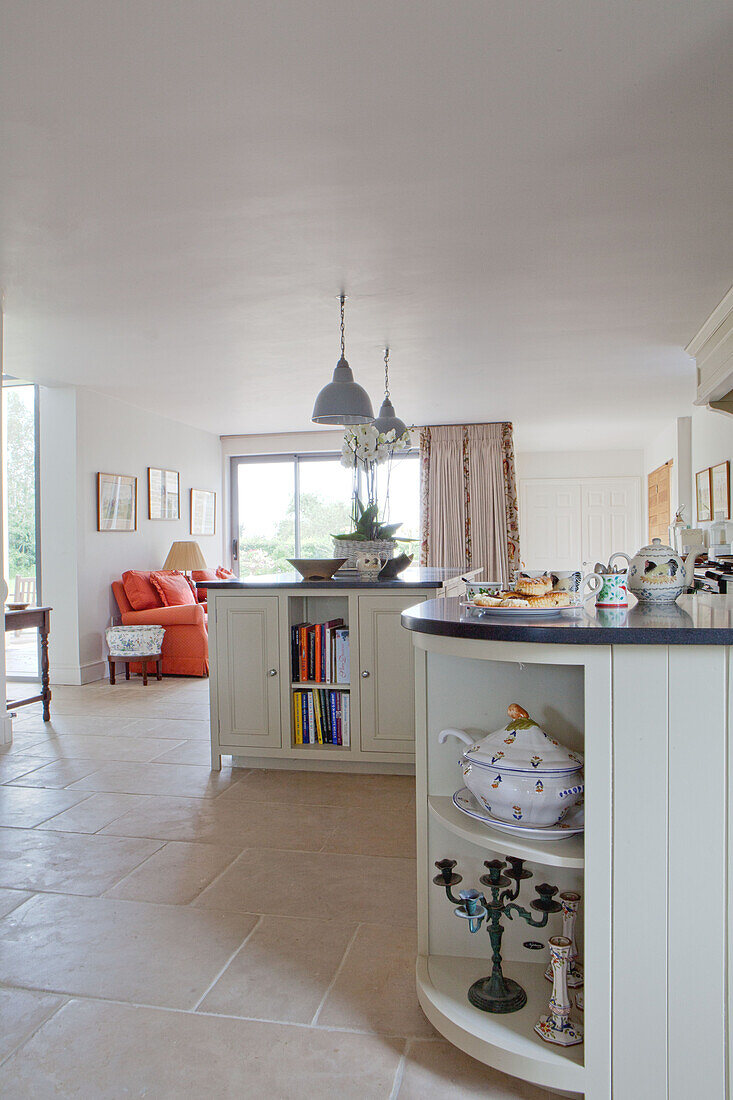 Fitted kitchen units and tile floor in open plan Wiltshire country house England UK