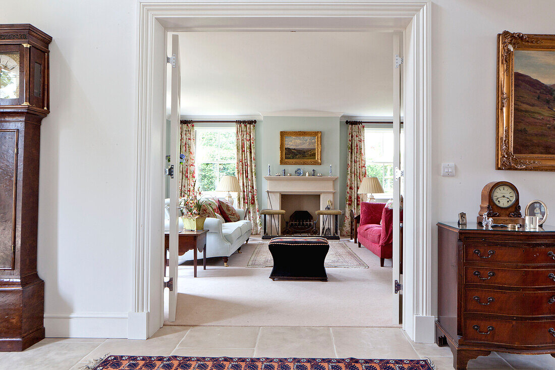 View through double doors to living room in Wiltshire country house England UK
